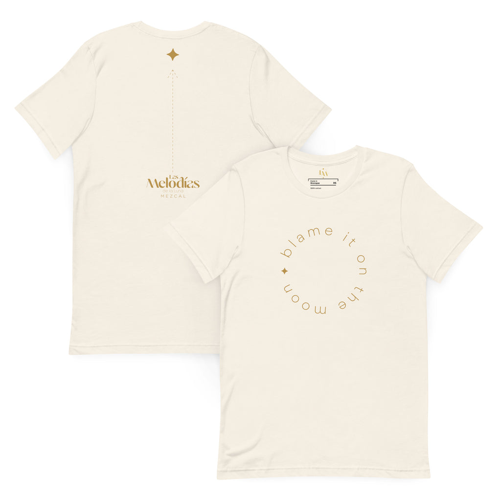 Off-white short-sleeve t-shirt showing the front and back. The front features a gold circular graphic reading 'blame it on the moon' with a small gold heart.